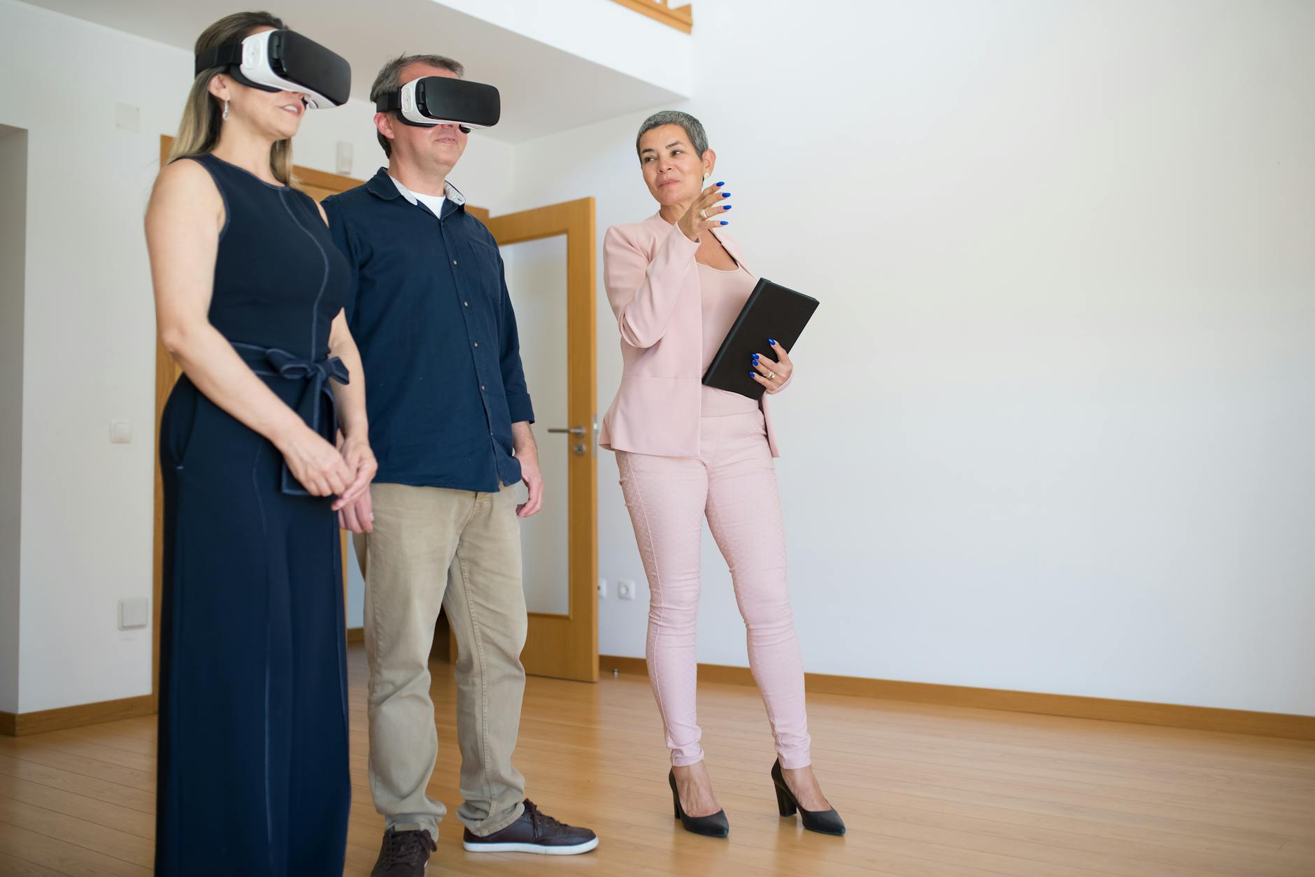 a couple using a virtual reality headset beside a realtor