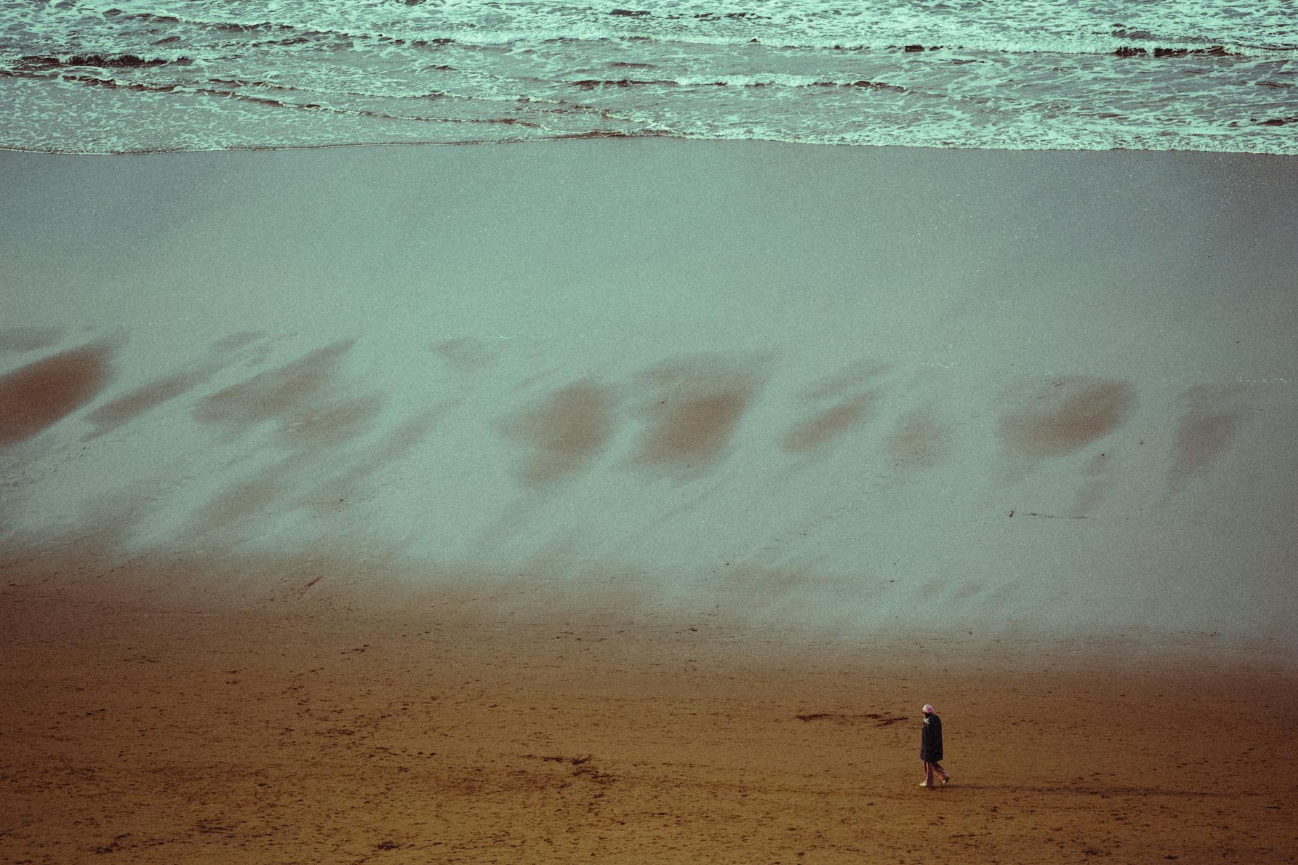 high angle view of a person walking on the beach